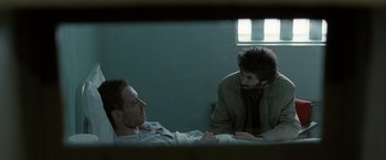 Movie still from “Hunger” (2008), directed by Steve McQueen – Two men sitting on a bed talking to each other; Medium shot, Over the shoulder angle