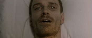 Movie still from “Hunger” (2008), directed by Steve McQueen – A man's face as he lies in bed; Close Up shot, Overhead angle
