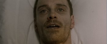 Movie still from “Hunger” (2008), directed by Steve McQueen – A man's face as he lies in bed; Close Up shot, Overhead angle