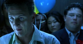 Movie still from “I Am Sam” (2001), directed by Jessie Nelson – A person with a blue balloon in the background; Close Up shot, Over the shoulder angle