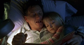 Movie still from “I Am Sam” (2001), directed by Jessie Nelson – A man and a little girl reading a book in bed; Close Up shot, High angle