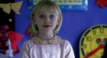Movie still from “I Am Sam” (2001), directed by Jessie Nelson – A little girl with blonde hair and blue eyes wearing a pink shirt; Close Up shot, Over the shoulder angle