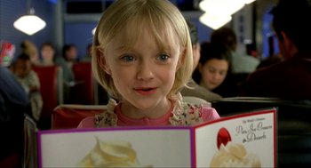 Movie still from “I Am Sam” (2001), directed by Jessie Nelson – A little girl is looking at the camera while holding a card; Close Up shot, Over the shoulder angle