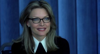 Movie still from “I Am Sam” (2001), directed by Jessie Nelson – A person wearing glasses and smiling; Close Up shot, Over the shoulder angle