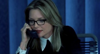 Movie still from “I Am Sam” (2001), directed by Jessie Nelson – A woman in a black shirt is talking on a phone; Close Up shot, High angle