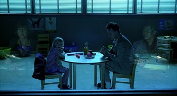 Movie still from “I Am Sam” (2001), directed by Jessie Nelson – A man and a little girl sitting at a table; Wide shot, Over the shoulder angle