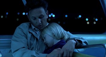 Movie still from “I Am Sam” (2001), directed by Jessie Nelson – A man and a little girl sitting next to each other; Close Up shot, High angle