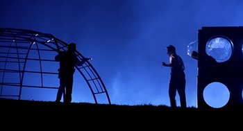 Movie still from “I Am Sam” (2001), directed by Jessie Nelson – Two people standing on top of a hill at night; Wide shot, Low angle