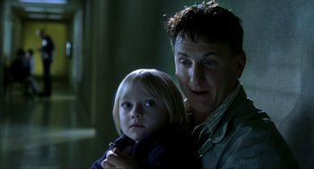Movie still from “I Am Sam” (2001), directed by Jessie Nelson – A man and a little girl standing next to each other; Close Up shot, Low angle