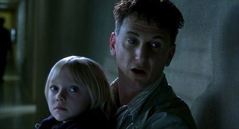 Movie still from “I Am Sam” (2001), directed by Jessie Nelson – A man and a little girl looking surprised; Close Up shot, Low angle