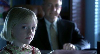 Movie still from “I Am Sam” (2001), directed by Jessie Nelson – A little girl sitting next to a man in a suit and tie; Close Up shot, Over the shoulder angle