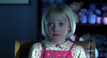 Movie still from “I Am Sam” (2001), directed by Jessie Nelson – A little girl sitting in a chair with a stuffed animal; Close Up shot, High angle