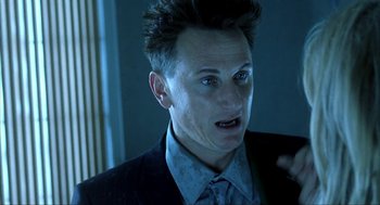 Movie still from “I Am Sam” (2001), directed by Jessie Nelson – A person wearing a suit and tie; Close Up shot, Low angle