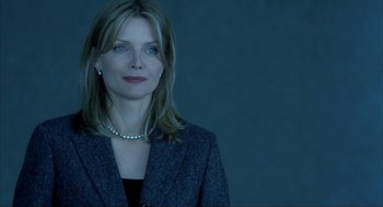 Movie still from “I Am Sam” (2001), directed by Jessie Nelson – A woman in a suit and a necklace; Close Up shot, Low angle