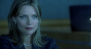 Movie still from “I Am Sam” (2001), directed by Jessie Nelson – A person wearing a suit and a pearl necklace; Close Up shot, Low angle