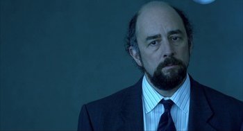 Movie still from “I Am Sam” (2001), directed by Jessie Nelson – A man in a suit and a tie looking to his left; Close Up shot, Over the shoulder angle