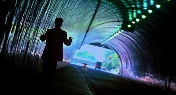 Movie still from “I Am Sam” (2001), directed by Jessie Nelson – A man in a suit and tie standing in front of a tunnel; Wide shot, Low angle