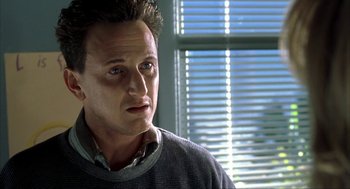 Movie still from “I Am Sam” (2001), directed by Jessie Nelson – A person wearing a sweater near a window; Close Up shot, Low angle