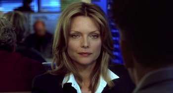 Movie still from “I Am Sam” (2001), directed by Jessie Nelson – A person wearing a suit and tie; Close Up shot, Over the shoulder angle