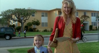 Movie still from “I Am Sam” (2001), directed by Jessie Nelson – A woman and a girl standing in front of a house; Medium shot, Low angle
