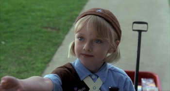 Movie still from “I Am Sam” (2001), directed by Jessie Nelson – A young girl wearing a brown hat and a brown tie; Close Up shot, Over the shoulder angle