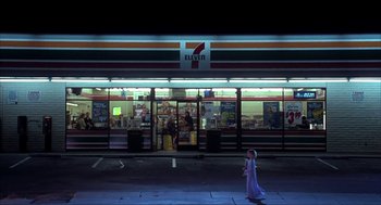 Movie still from “I Am Sam” (2001), directed by Jessie Nelson – A little girl is standing in front of a 7 - 1 1 store; Extreme Wide shot, Low angle