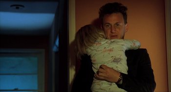 Movie still from “I Am Sam” (2001), directed by Jessie Nelson – A man holding a little girl in his arms; Medium shot, Low angle