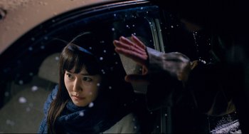 Movie still from “I Saw the Devil” (2010), directed by Jee-woon Kim – A woman in a car looking out the window at a man; Close Up shot, Over the shoulder angle