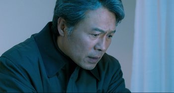 Movie still from “I Saw the Devil” (2010), directed by Jee-woon Kim – A person with blue hair; Close Up shot, Low angle