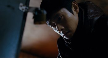 Movie still from “I Saw the Devil” (2010), directed by Jee-woon Kim – A person wearing a black jacket; Close Up shot, Low angle