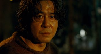 Movie still from “I Saw the Devil” (2010), directed by Jee-woon Kim – A person wearing a sweater; Close Up shot, Low angle