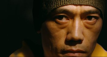 Movie still from “I Saw the Devil” (2010), directed by Jee-woon Kim – A man's face wearing a hat; Extreme Close Up shot, Low angle