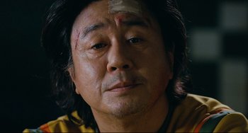 Movie still from “I Saw the Devil” (2010), directed by Jee-woon Kim – A person with a bandage on his head; Close Up shot, Low angle