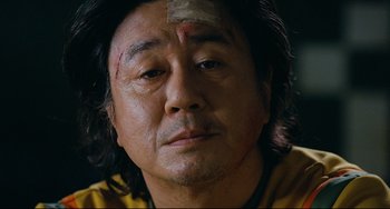 Movie still from “I Saw the Devil” (2010), directed by Jee-woon Kim – A person with a bandage on his head; Close Up shot, Low angle