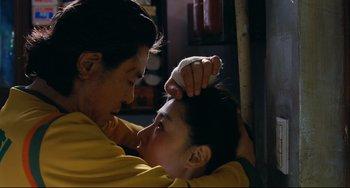 Movie still from “I Saw the Devil” (2010), directed by Jee-woon Kim – A man and a woman are combing each other's hair; Close Up shot, Low angle