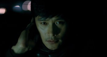 Movie still from “I Saw the Devil” (2010), directed by Jee-woon Kim – A person wearing a leather jacket; Close Up shot, High angle