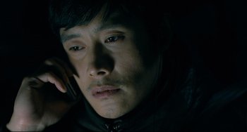 Movie still from “I Saw the Devil” (2010), directed by Jee-woon Kim – A person talking on a cell phone; Close Up shot, High angle