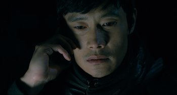 Movie still from “I Saw the Devil” (2010), directed by Jee-woon Kim – A person talking on a cell phone; Close Up shot, High angle