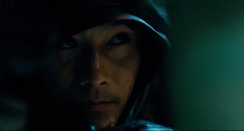Movie still from “I Saw the Devil” (2010), directed by Jee-woon Kim – A person with a hood on; Extreme Close Up shot, Low angle