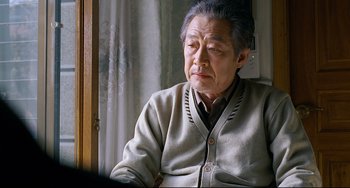 Movie still from “I Saw the Devil” (2010), directed by Jee-woon Kim – An older man sitting in front of a window; Close Up shot, Over the shoulder angle