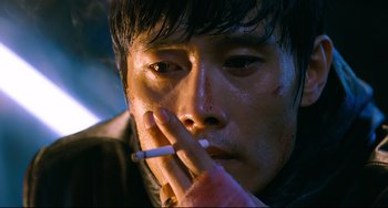 Movie still from “I Saw the Devil” (2010), directed by Jee-woon Kim – A person smoking a cigarette; Close Up shot, High angle