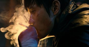Movie still from “I Saw the Devil” (2010), directed by Jee-woon Kim – A young man smoking a cigarette in the dark; Close Up shot, Low angle