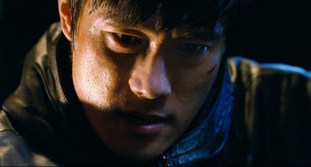 Movie still from “I Saw the Devil” (2010), directed by Jee-woon Kim – A man's face in the dark; Close Up shot, Low angle
