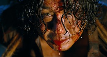 Movie still from “I Saw the Devil” (2010), directed by Jee-woon Kim – A man with blood on his face and a bunch of hair on his head; Extreme Close Up shot, Low angle