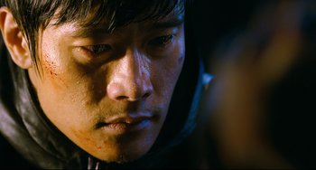 Movie still from “I Saw the Devil” (2010), directed by Jee-woon Kim – A man's face in the dark; Close Up shot, Over the shoulder angle