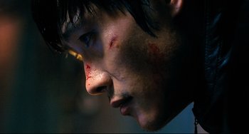 Movie still from “I Saw the Devil” (2010), directed by Jee-woon Kim – A man's face with blood all over his face; Close Up shot, Low angle