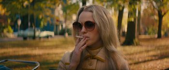 Movie still from “I'm Your Woman” (2020), directed by Julia Hart – A woman in sunglasses is smoking a cigarette; Medium shot, Over the shoulder angle