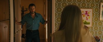 Movie still from “I'm Your Woman” (2020), directed by Julia Hart – A man and a woman standing in front of a door; Medium shot, Over the shoulder angle