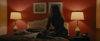 Movie still from “I'm Your Woman” (2020), directed by Julia Hart – A woman and a baby on a bed in a room; Medium shot, High angle