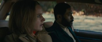 Movie still from “I'm Your Woman” (2020), directed by Julia Hart – A woman and a man sitting in the back of a car; Close Up shot, Over the shoulder angle